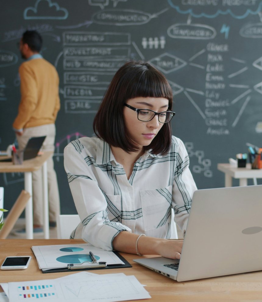School hiring lead reviewing teacher applications at a laptop