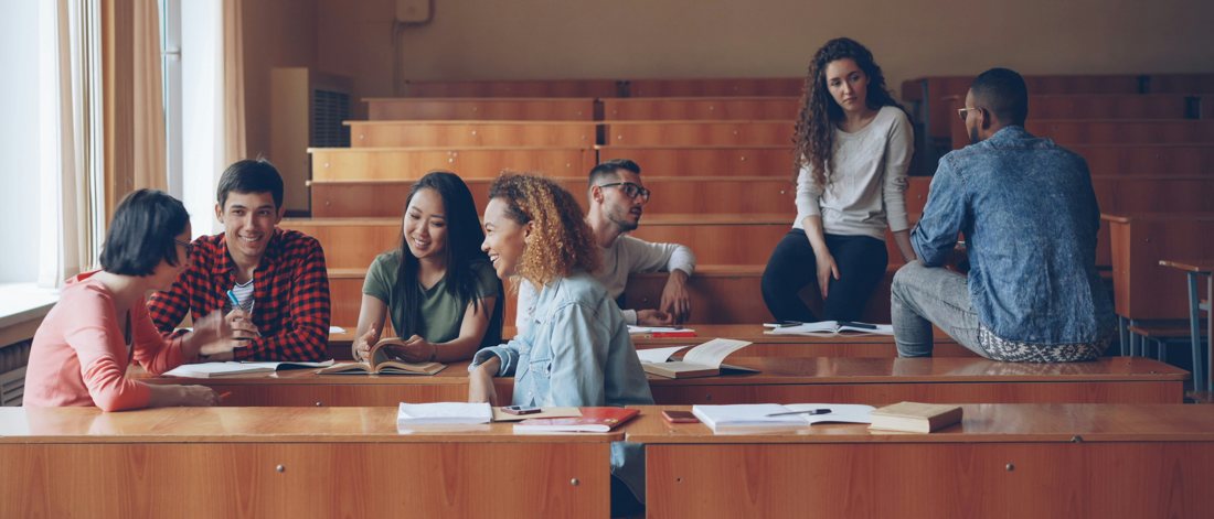 Students collaborating in a university lecture hall