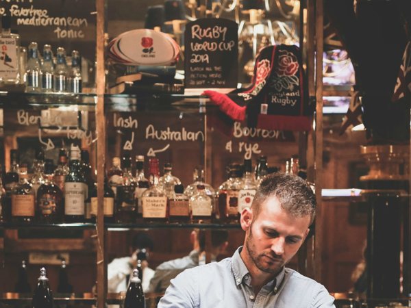 Bartender mixing cocktails behind the bar